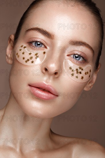 Beautiful fresh girl with cosmetic patches under the eyes