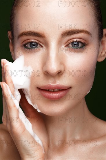 Beautiful young girl with facial wash on the skin. Beauty face. Picture taken in the studio