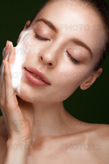 Beautiful young girl with facial wash on the skin. Beauty face. Picture taken in the studio