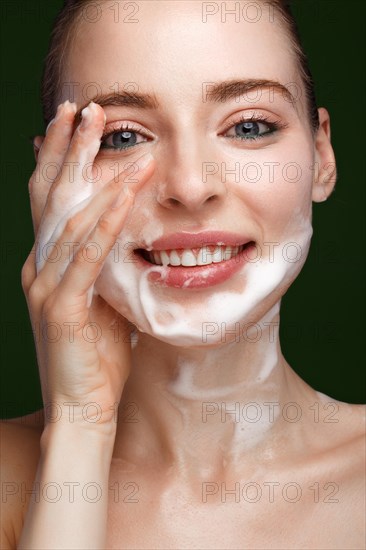 Beautiful young girl with facial wash on the skin. Beauty face. Picture taken in the studio