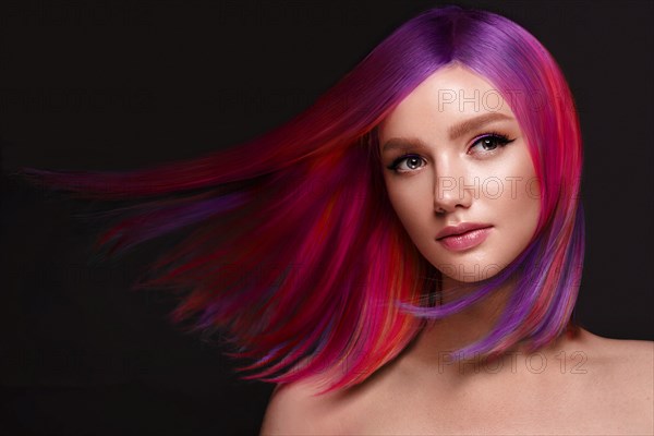 Portrait of beautiful woman with multi-colored hair and creative make up and hairstyle