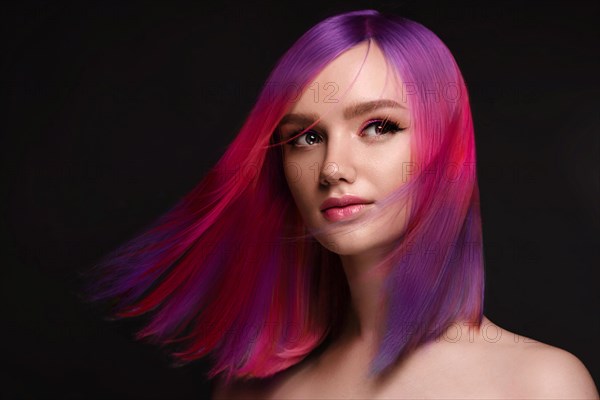 Portrait of beautiful woman with multi-colored hair and creative make up and hairstyle