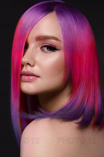 Portrait of beautiful woman with multi-colored hair and creative make up and hairstyle