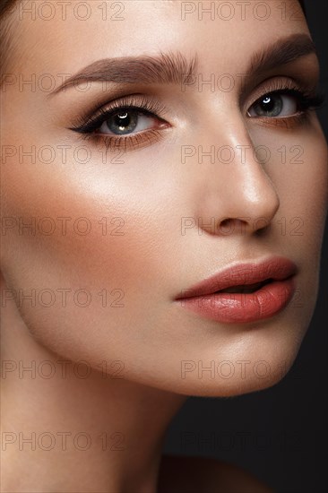 Beautiful girl with sexy lips and classic makeup. Beauty face. Photo taken in the studio