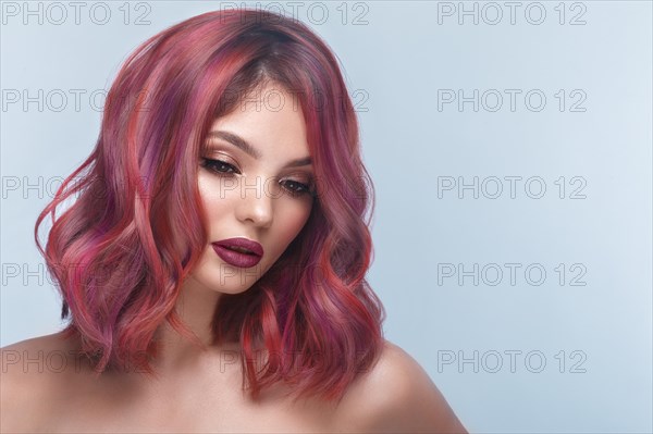 Beautiful girl with multi-colored hair and classic make-up and hairstyle. Beauty face. Photo taken in the studio