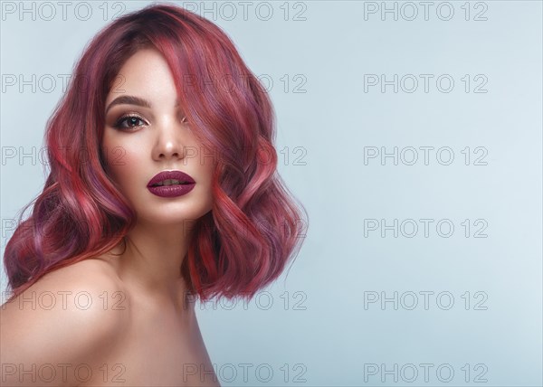 Beautiful girl with multi-colored hair and classic make-up and hairstyle. Beauty face. Photo taken in the studio