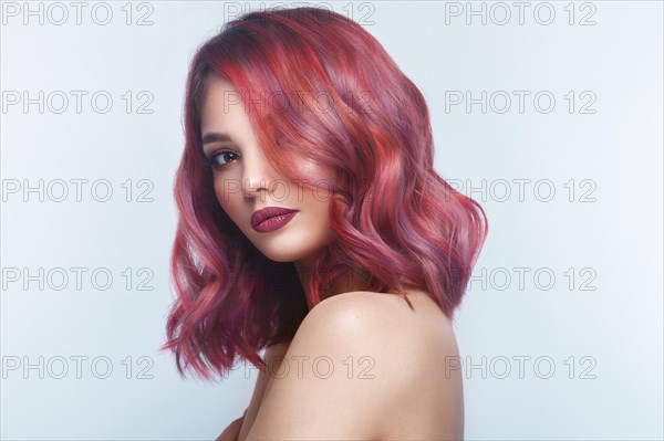 Beautiful girl with multi-colored hair and classic make-up and hairstyle. Beauty face. Photo taken in the studio