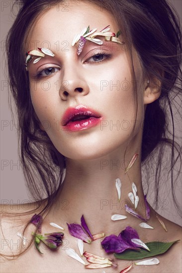 Beautiful girl with art make-up and flowers. beauty face. Photos shot in studio