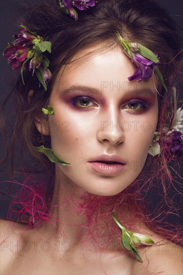 Beautiful girl with art make-up and flowers. beauty face. Photos shot in studio
