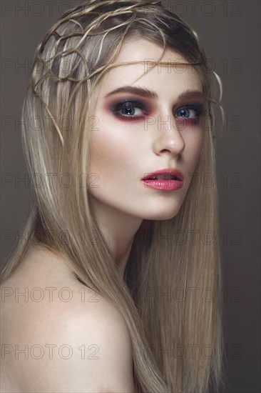 Beautiful fashion woman with creative make-up and hairstyle. The beauty of the face. Photos shot in the studio