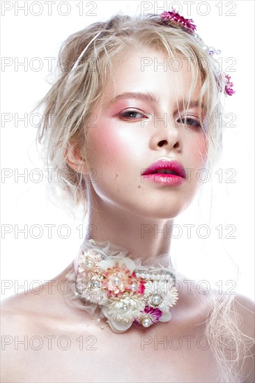 Beautiful blond fashion girl with flowers on the neck and in her hair