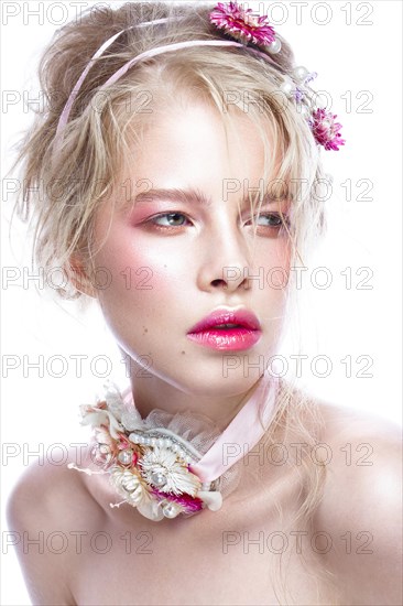 Beautiful blond fashion girl with flowers on the neck and in her hair