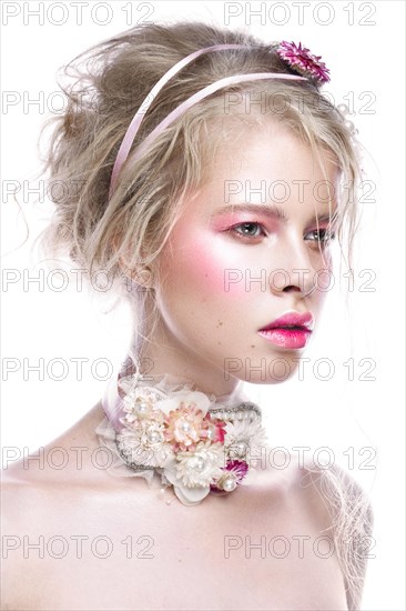 Beautiful blond fashion girl with flowers on the neck and in her hair