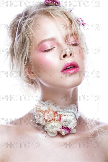 Beautiful blond fashion girl with flowers on the neck and in her hair