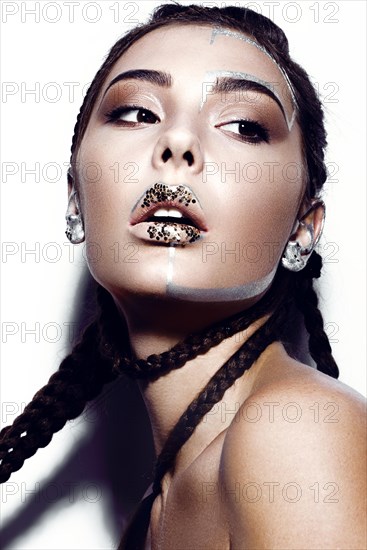 Portrait of a Beautiful fashionable girl with a creative glitter make-up