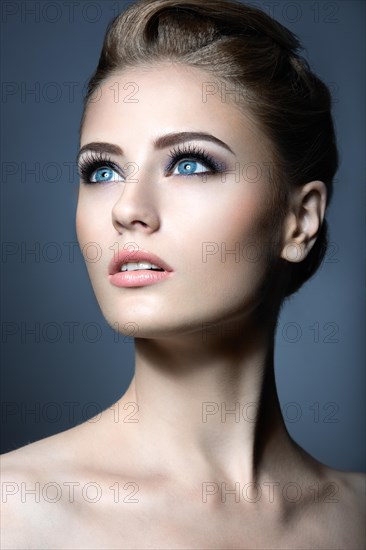 Beautiful girl with a light Nude make-up and blond hair. Beauty face. Picture taken in the studio on a white background