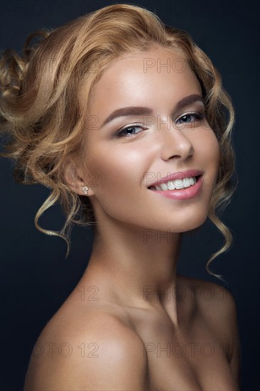 Portrait of a beautiful blond woman in the image of the bride. Picture taken in the studio on a black background. Beauty face and Hairstyle