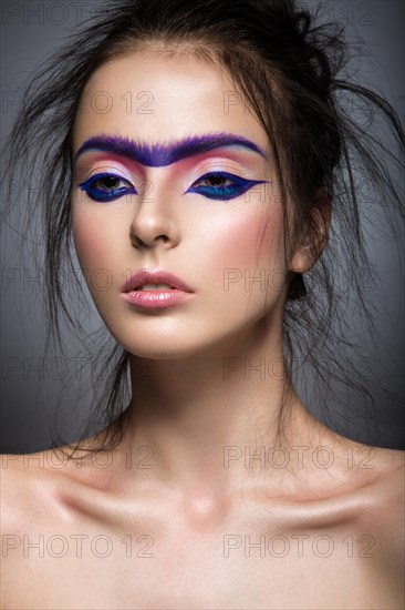 Fashion model with bright make-up art with a solid eyebrow. Creative image. Picture taken in the studio