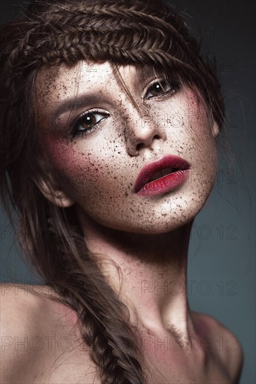 Beautiful strange girl with creative art make-up. Beauty face. Photo taken in studio