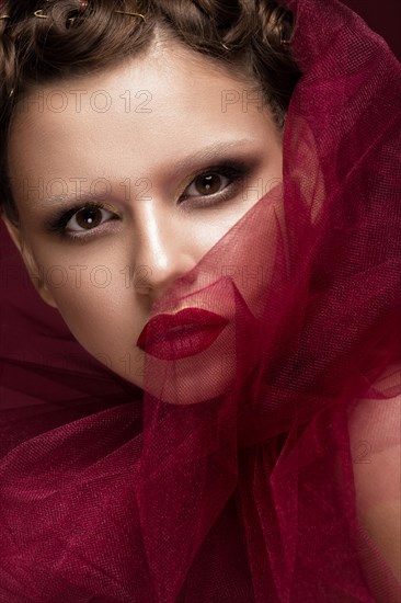 Beautiful girl with art creative make-up in the image of a red bride for Halloween. Beauty face. Photo taken in studio