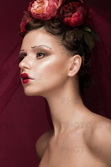 Beautiful girl with art creative make-up in the image of a red bride for Halloween. Beauty face. Photo taken in studio