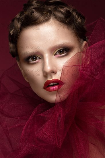 Beautiful girl with art creative make-up in the image of a red bride for Halloween. Beauty face. Photo taken in studio