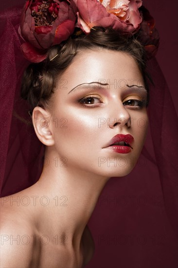 Beautiful girl with art creative make-up in the image of a red bride for Halloween. Beauty face. Photo taken in studio