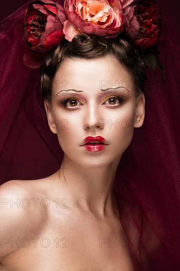 Beautiful girl with art creative make-up in the image of a red bride for Halloween. Beauty face. Photo taken in studio