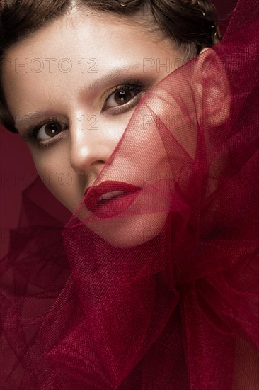 Beautiful girl with art creative make-up in the image of a red bride for Halloween. Beauty face. Photo taken in studio