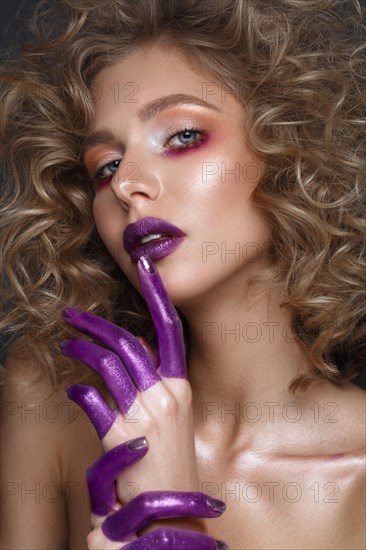 Beautiful blonde girl with curls and art creative make-up. Beauty face. Photos shot in the studio