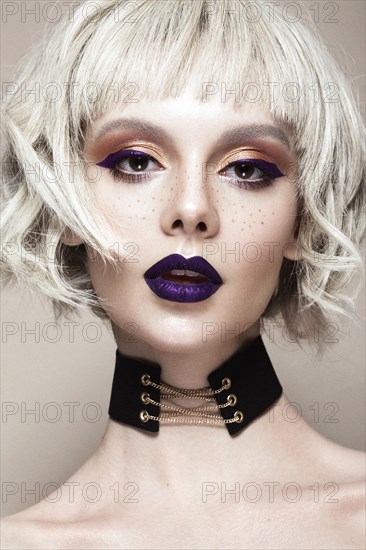 Beautiful woman with art makeup and a fashionable hair. The beauty of the face. Portrait shot in studio