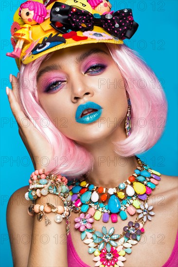 Funny comic girl with bright make-up in the style of pop art. Creative image. Beauty face. Photo taken in the studio