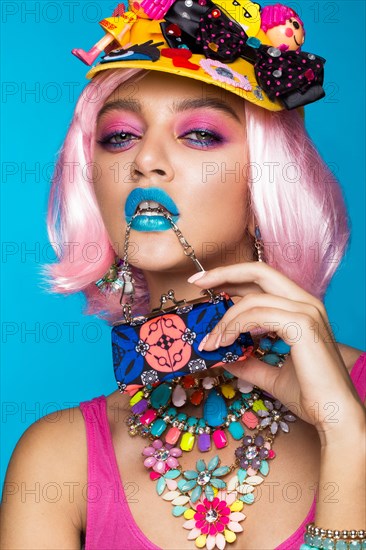 Funny comic girl with bright make-up in the style of pop art. Creative image. Beauty face. Photo taken in the studio