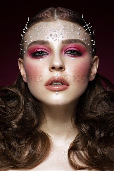 Beautiful girl with perfect art makeup and pearl beads. beauty face. Photos shot in the studio