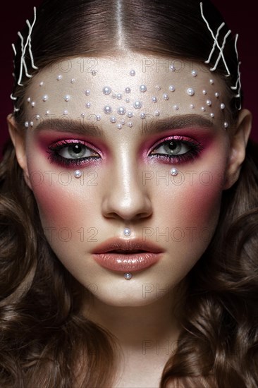 Beautiful girl with perfect art makeup and pearl beads. beauty face. Photos shot in the studio