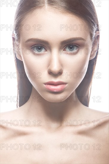 Beautiful girl with a light Nude make-up and blond hair. Beauty face. Picture taken in the studio on a white background