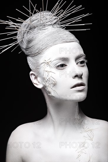 Art fashion girl with white skin and unusual hairstyle. Creative art beauty. Picture taken in the studio on a black background