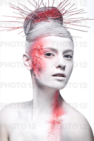 Art fashion girl with white skin and red paint on the face. Creative art beauty. Picture taken in the studio on a black background