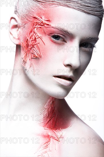 Art fashion girl with white skin and red paint on the face. Creative art beauty. Picture taken in the studio on a black background