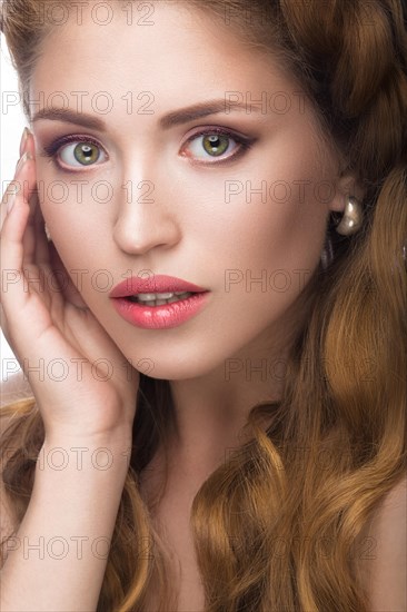 Fashion beautiful girl oriental type with delicate natural make-up and flowers. Beauty face. Picture taken in the studio on a white background