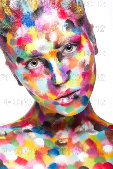 Girl with colored face painted. Art beauty image. Picture taken in the studio on a white background