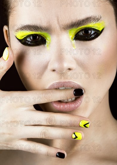 Close-up portrait of girl with yellow and black make-up