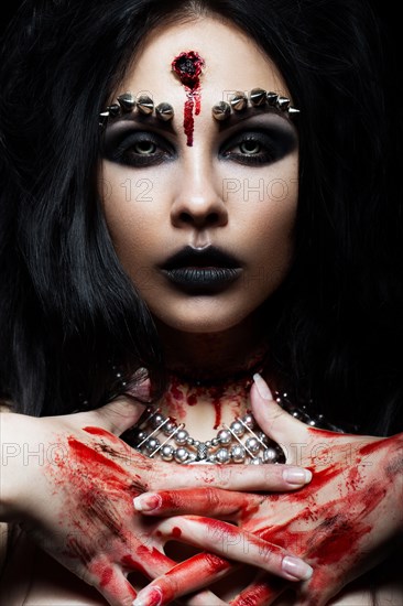 Demon girl with a bullet in the head and her throat cut. An image for Halloween. Photos shot in studio