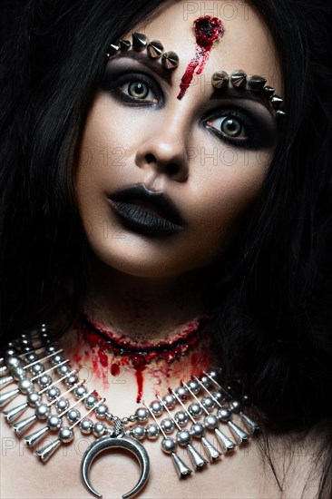 Demon girl with a bullet in the head and her throat cut. An image for Halloween. Photos shot in studio