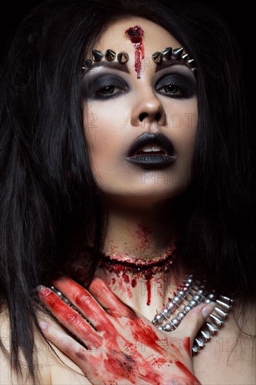 Demon girl with a bullet in the head and her throat cut. An image for Halloween. Photos shot in studio