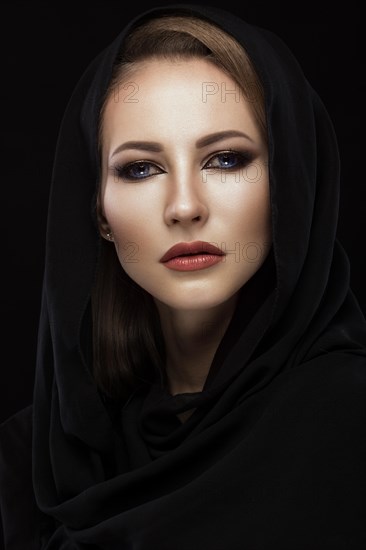 Beautiful girl in the Arab scarf with oriental make-up. Beauty face. Photos shot in the studio