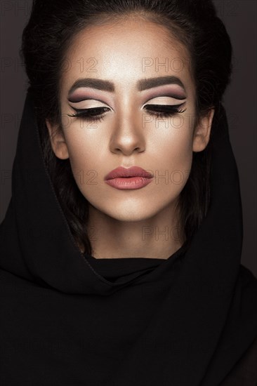 Beautiful girl in the Arab scarf with oriental make-up. Beauty face. Photos shot in the studio