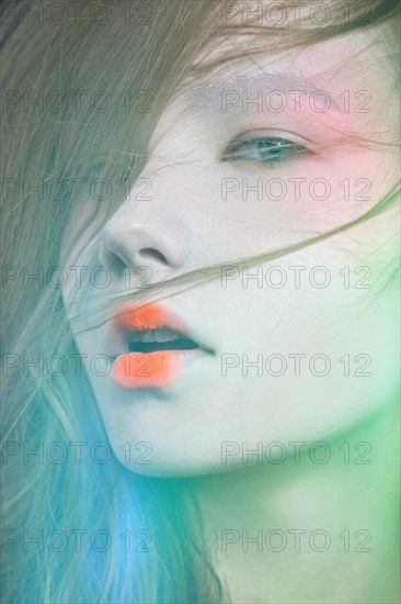 Portrait of a beautiful Girl in the image of a Geisha. Photo shot in the Studio on a black background. Unusual image and makeup