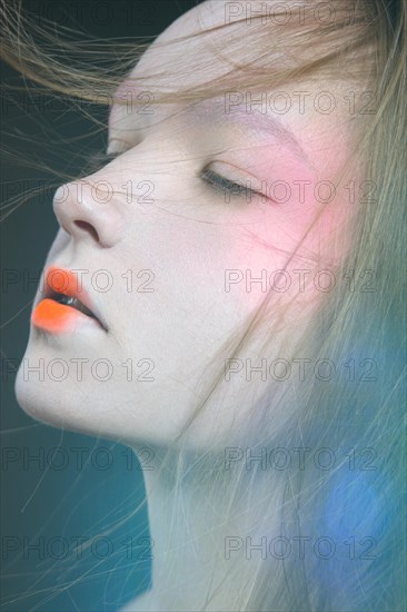 Portrait of a beautiful Girl in the image of a Geisha. Photo shot in the Studio on a black background. Unusual image and makeup