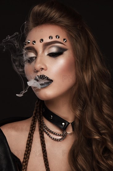 Portrait of a beautiful woman in a rock style image with creative makeup and hairstyle